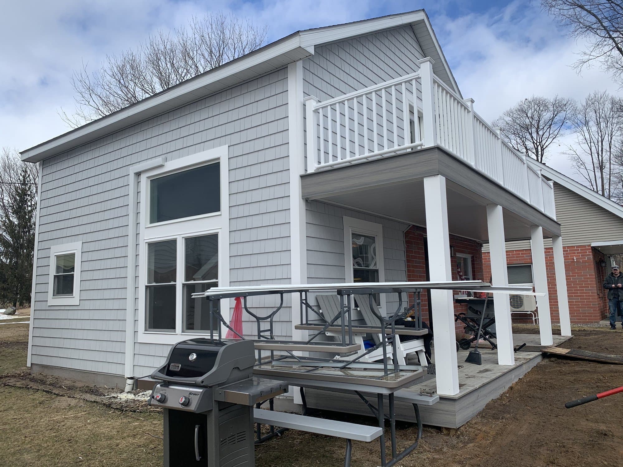 Gray home addition and exterior work by TNT Construction