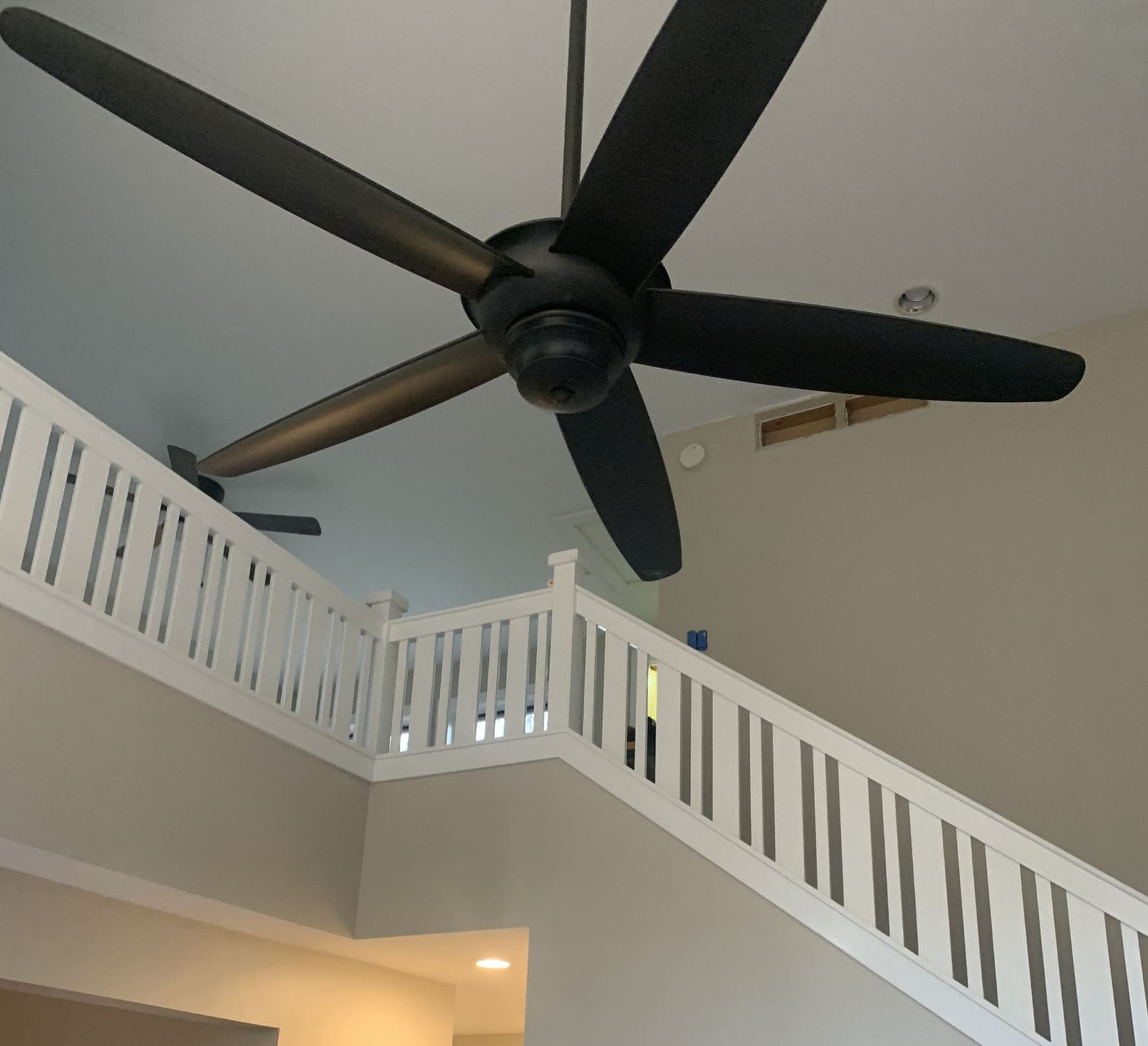 Interior painting around a stairwell and vaulted ceiling